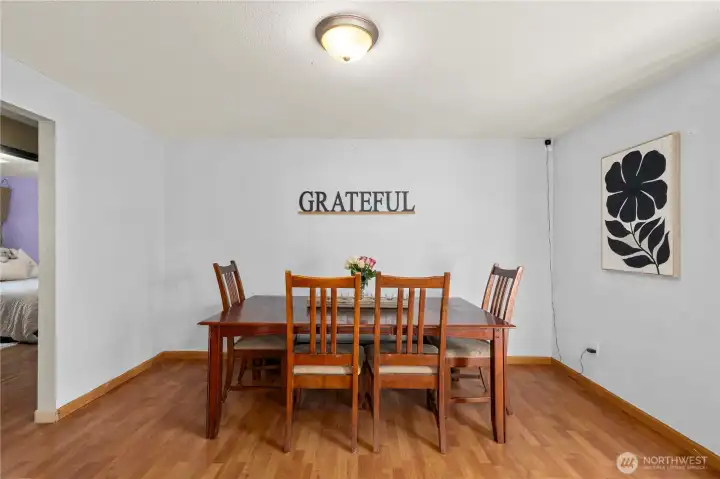 Bright and open dining space connects directly to the kitchen, ideal for hosting meals or creating a casual breakfast nook. Laminate flooring keeps maintenance simple and durable.