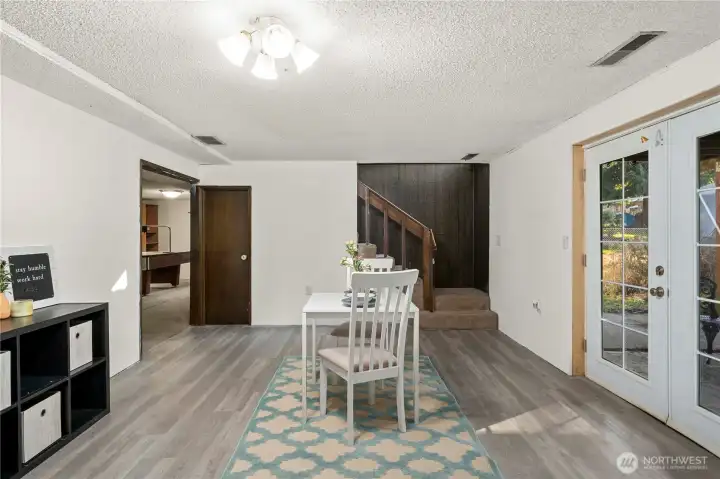 The lower level features a spacious kitchenette and dining area with French doors leading to the backyard patio, offering great natural light and easy indoor–outdoor flow. Updated flooring adds a fresh touch, making this a functional and comfortable space for guests, extended family, or entertaining.