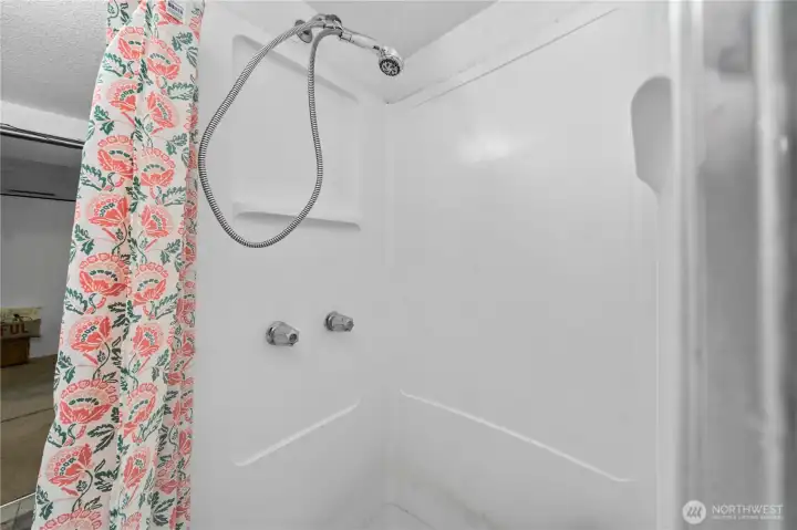 Complete with a walk-in shower, this combined space provides comfort and accessibility for multigenerational living or guests, keeping everything needed within easy reach on one level.