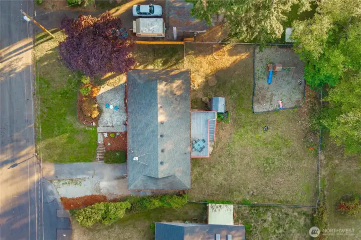Top-down view showing the full property footprint — generous yard space, patio, and play area — all thoughtfully arranged for comfort and outdoor enjoyment.
