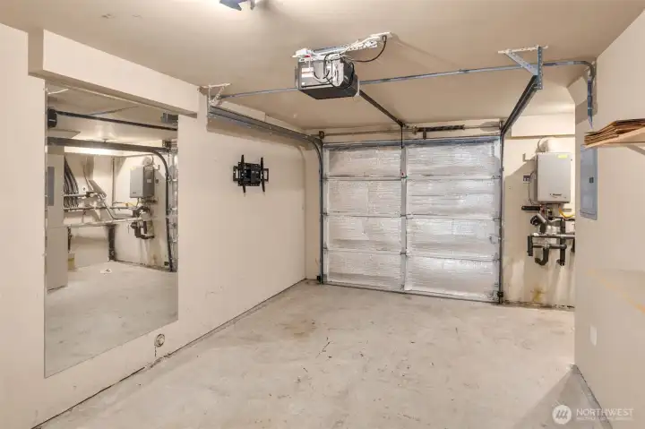 Large garage space w/ storage tucked around the corner