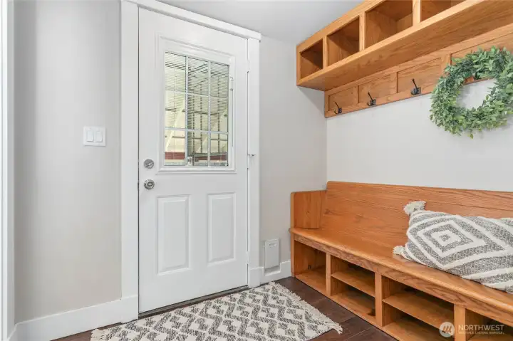 Quaint back door entry with built-in coat rack + bench with organizer