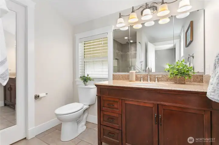 Primary bathroom off bedrooms has tile walk-in shower, heated tile floors and walk-in closet