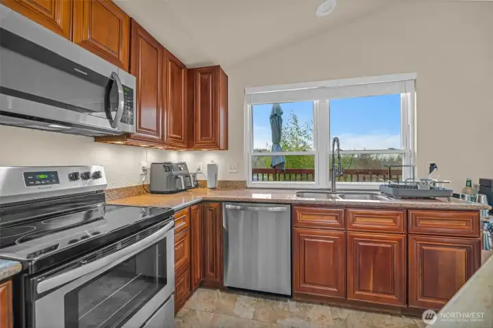 updated kitchen with granite countertops, stainless steel appliances, and quality cabinets.