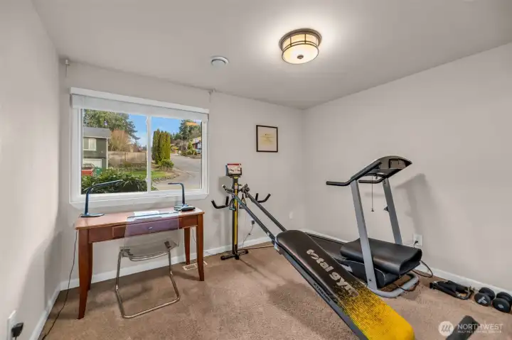One of the three bedrooms used as a work out room or office.