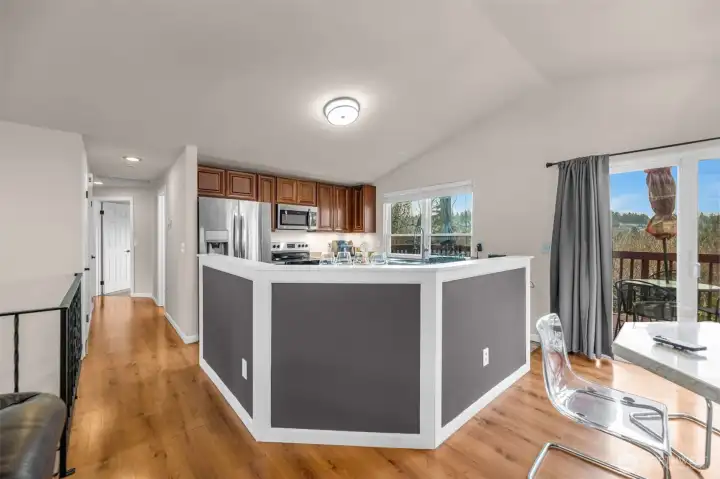 The kitchen is open concept, seamlessly connecting to the dining and living areas, creating a bright, spacious hub perfect for gathering and entertaining.