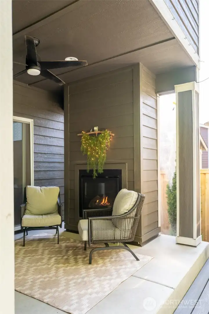 Covered patio with outdoor fireplace.