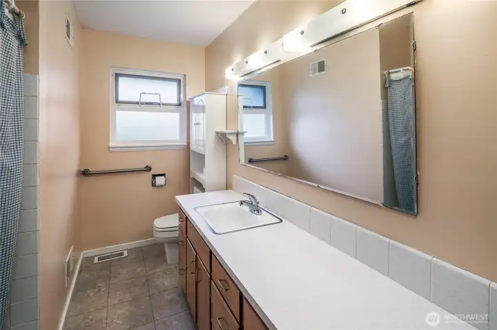 The full bath in the hall services the 3 bedrooms. It has tile accents on counter and tile in the tub. The full bath in the hall services the 3 bedrooms. It has tile accents on counter and tile in the tub.