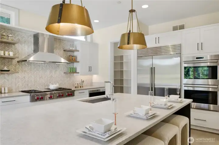 Wolf cooktop, double ovens, and Sub-Zero refrigerator elevate everyday cooking