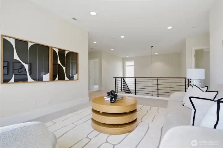 Alternate view of the upper-level loft showcasing the sleek, modern railing and open sightlines