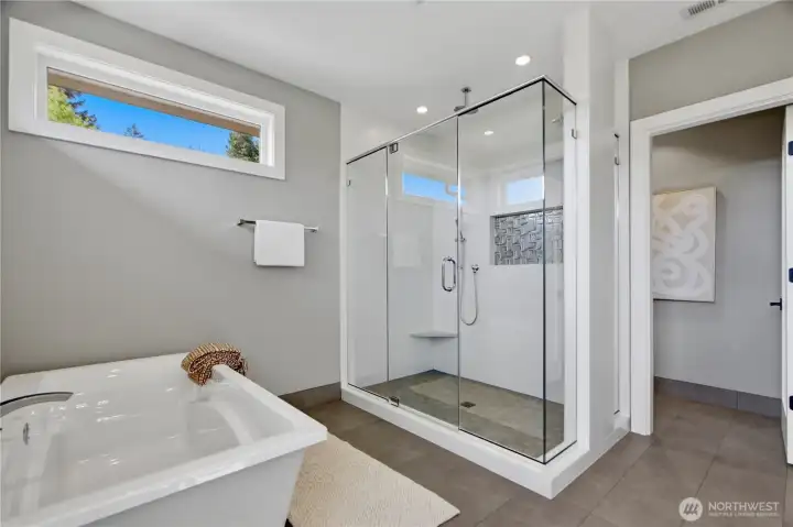 Spa-inspired primary bathroom suite with a large walk-in shower, soaking tub, and private water closet for added comfort and privacy