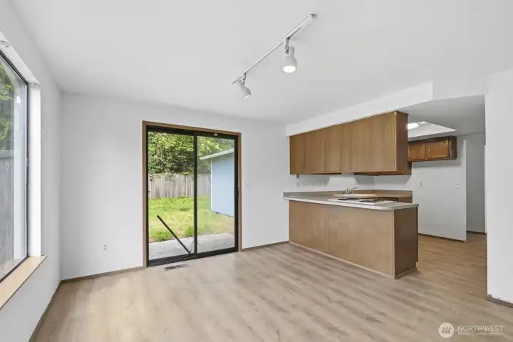 Another view of the kitchen with dining area that leads to the backyard.