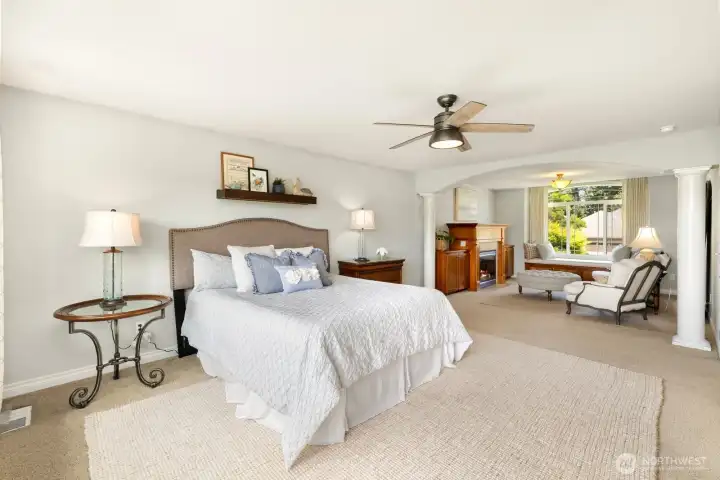 Stunning and private primary suite with generously sized sitting area.  High-end custom window coverings and a cozy gas fireplace.   Perfect retreat for slow mornings and evening relaxation!