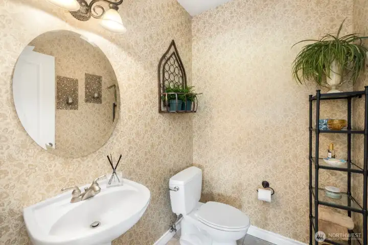 Downstairs powder room with designer wallpaper and finishes.