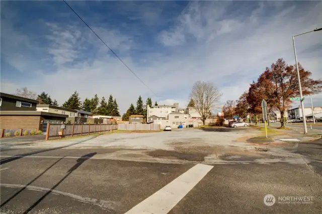 This picture is looking North from the Corner of NE 117th St & 15th Ave NE.  There are 2 vacant land tax parcels.  The parcel closest to the street is approximately 6250 sqft, and the next vacant parcel is 7020 sqft. Then there are 2 buildings, that are included, a Day Care, a Children's clothing, and a 2 bedroom house.