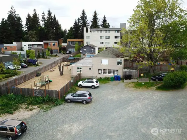 The first building is the Whiz Kid's Daycare, and their play ground.  In the back ground is a dark brown single family home, which is located behind Kym's Kiddy Corner.  This house rents for $800 per month