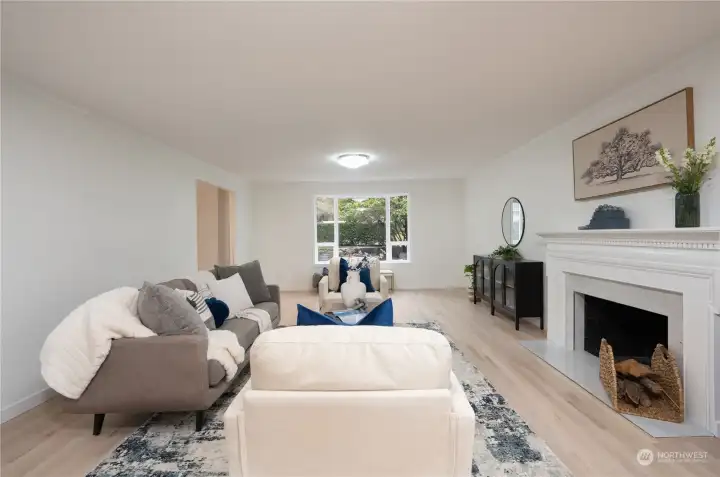 Huge bay window brings in the sunshine while opening up to the manicured front yard