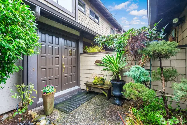 This second photo of the entryway shows the landscaping details which make a welcoming presentation as you enter or leave your home.