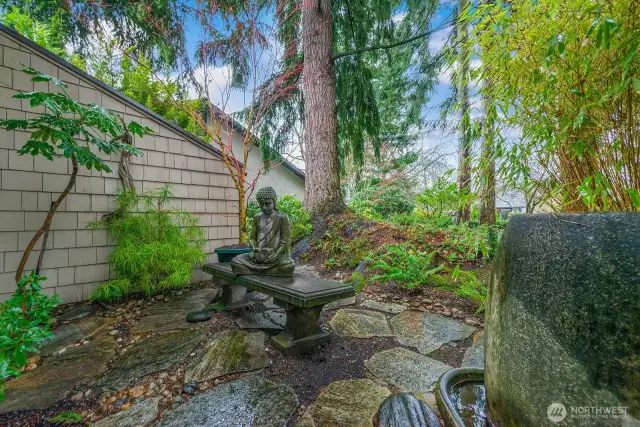 Looking out to the backyard you'll find the landscaping details which create a wonderful vista from the living room's east facing wall of windows.