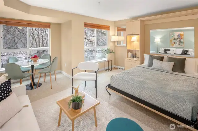 Natural light floods in from two walls of windows, creating a peaceful retreat and cozy dining corner all in one.