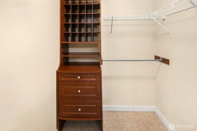 Organization goals met: a walk-in closet with built-in drawers, cubbies and plenty of hanging keeps everything tidy and within easy reach.