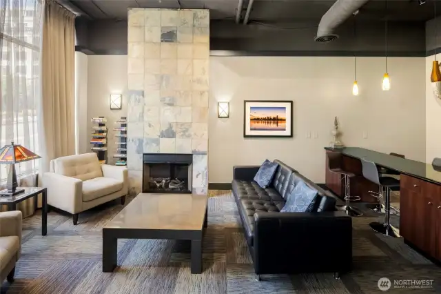 Need a change of scenery? Settle into the building's shared lounge with striking fireplace, soaring ceilings, and soft natural light.