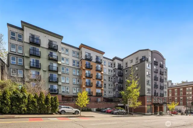 Stylish and secure—Tobira welcomes you home with a modern lobby, brick detailing, and easy access to parking, transit, and downtown life.