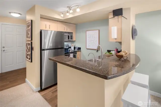 Welcome in! The kitchen’s granite counters and stainless appliances make an elegant first impression—plus there’s plenty of prep space for your inner chef.