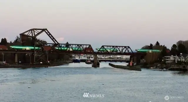 Boeing fusilages pass on the famous Salmon Bay bascule bridge.