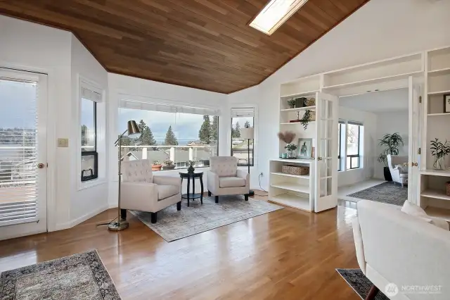 Soaring vaulted ceilings with skylight and windows, so much light! Versatile floor plan with a seamless flow between rooms. Door on the left edge of photo leads to your updated Trex view deck.