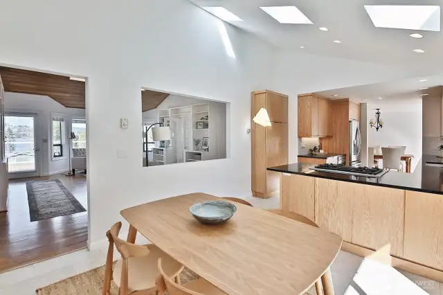 High ceilings, sky lights and an opening between the family room & kitchen continue the theme of light. Plenty of space for an eat-in kitchen.