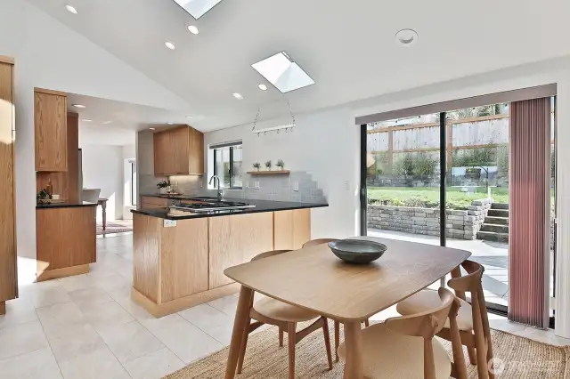 There is plenty of room at the counter for a few bar stools. Glass doors open to your pristine backyard patio. Let's step outside for a quick peek......