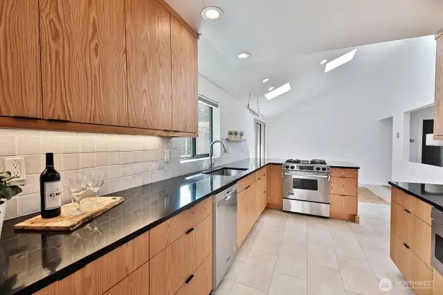 Remodeled kitchen with oak cabinets and propane range/oven. Be sure to check out the under counter microwave (see right edge of this photo for a glimpse of the microwave).