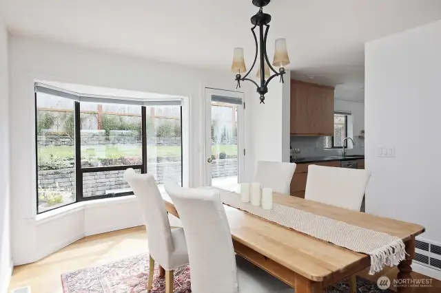 Dining room has a glass door to your backyard patio. Your back is to the stairs that lead to the upper primary and to the two-car garage.