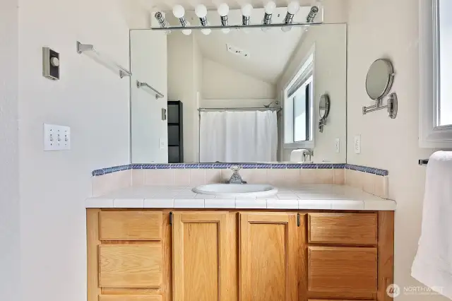 Full bath. This one has not been updated during Seller's ownership and provides an opportunity to bring your own style to this bathroom. Window looks out at the backyard. Let's go back downstairs to check out the other bedrooms & bathrooms.