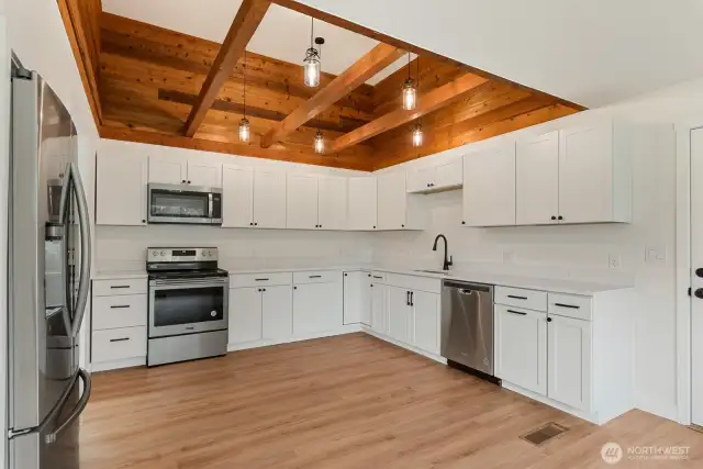 Beautiful open kitchen with recessed wood ceilings