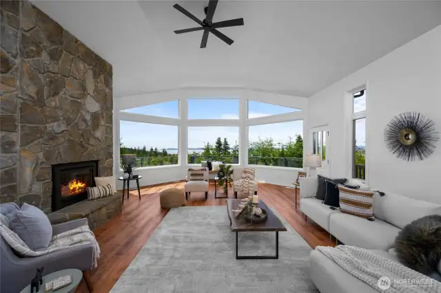 Grand vaulted living room with floor-to-ceiling stone fireplace and panoramic views.