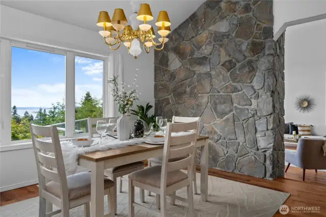 Dining room framed by windows and natural light- ideal for intimate or lively gatherings, all with a front-row seat to breathtaking westerly views