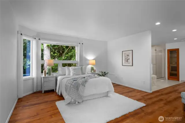 Tranquil main-floor primary suite with private deck access and spa-like ensuite.