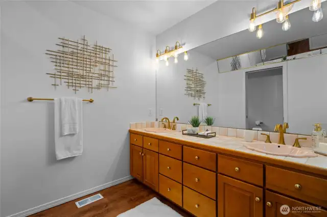 Spacious primary ensuite bath with dual sinks, custom fixtures, and an extra long vanity with ample storage.
