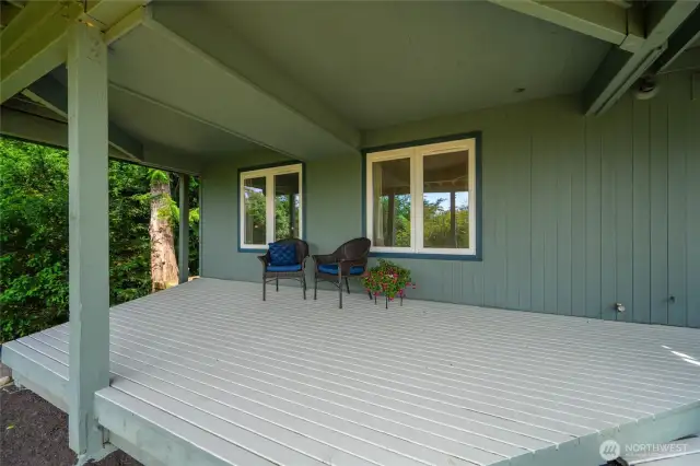 Tucked beneath the upper deck, this covered patio offers a peaceful retreat for the lower-level living area.