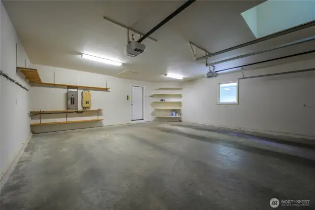 Spacious 2-car garage with ample storage and built-in shelving—perfect for tools, gear, or a workshop.