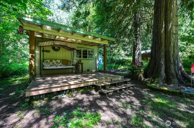 Side of the battery and generator shed with a cute covered deck area.