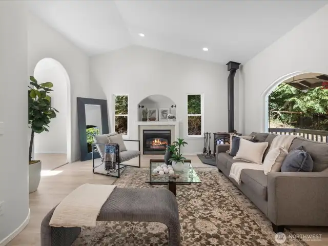 Step inside to an inviting living space flooded with natural light. Large windows bring the outdoors in, while the new flooring underfoot adds warmth and cohesion.