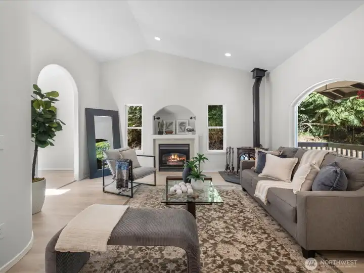 Step inside to an inviting living space flooded with natural light. Large windows bring the outdoors in, while the new flooring underfoot adds warmth and cohesion.