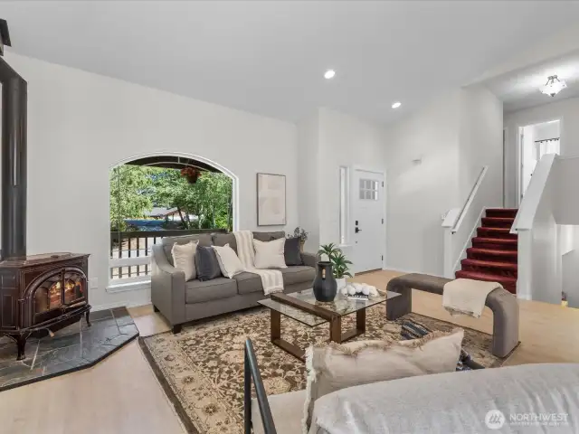 Large windows bring the outdoors in, while the new flooring underfoot adds warmth and cohesion.