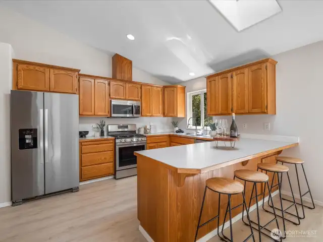 Featuring stainless steel appliances, tons of cabinet storage, a pantry with a brand-new door, and a breakfast bar perfect for casual meals or entertaining.