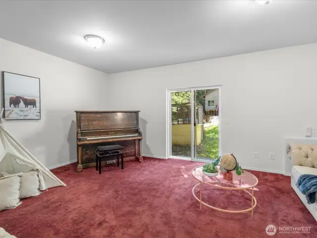 Downstairs (or den depending on layout), this fourth bedroom offers separation and flexibility—great for guests, a home gym, or a private office with a view of the trees. It also features dual closets.