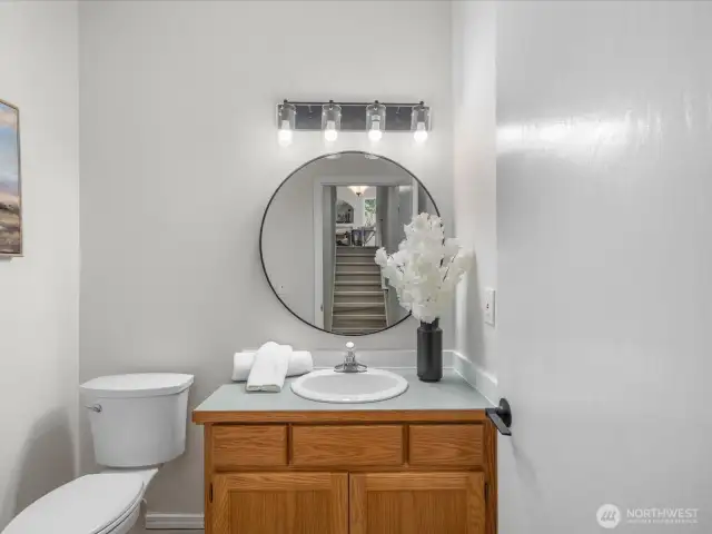 Conveniently located on the lower level, this updated half bath features fresh paint, new flooring, and stylish fixtures. A perfect blend of function and charm, it’s easily accessible for guests and everyday use.