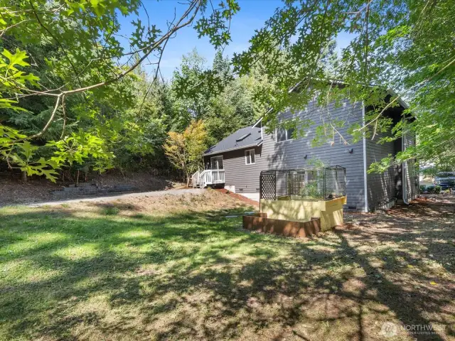 The expansive backyard is fully surrounded by trees, offering unmatched seclusion and a peaceful retreat.